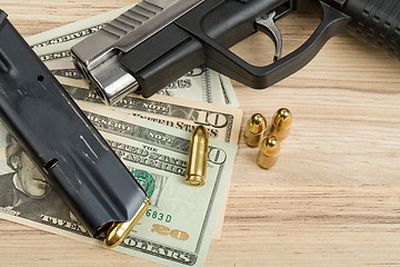 Image showing gun with bullet on US dollar banknotes