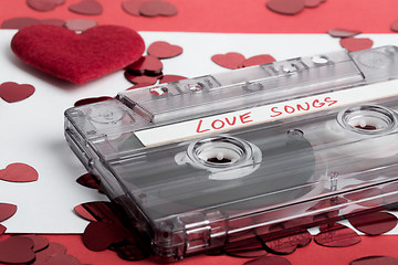 Image showing Audio cassette tape on red backgound with fabric heart