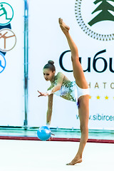 Image showing Young pretty girl shows exercise with ball