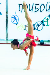 Image showing Young attractive girl shows exercise with maces