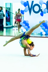 Image showing Young beautiful girl shows exercise with ball