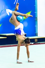 Image showing Young pretty girl shows exercise with ball