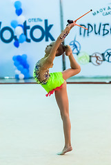 Image showing Young beautiful girl shows exercise with maces