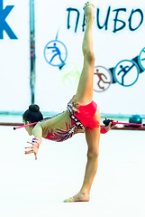 Image showing Young beautiful girl shows exercise with maces