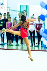 Image showing Young beautiful girl shows exercise with maces