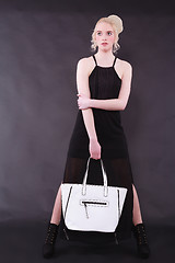 Image showing Young blond woman with white bag