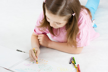 Image showing girl draws lying on the floor