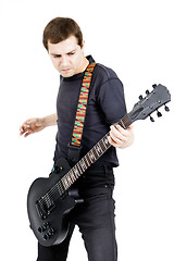 Image showing young man with an electric guitar. Isolated