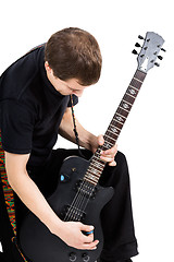 Image showing young man with an electric guitar. Isolated