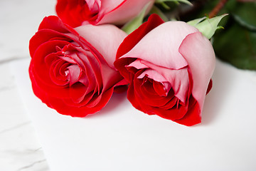 Image showing red roses and a blank sheet of paper