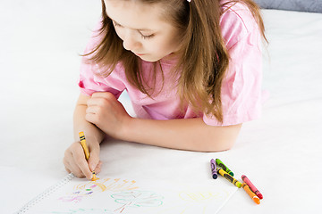 Image showing girl draws lying on the floor
