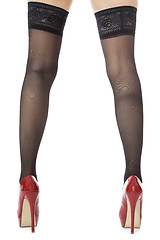 Image showing Woman Legs Wearing Red Shoes and Gray Stockings