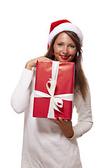 Image showing Pretty woman in a Santa hat with a large gift