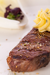 Image showing Grilled beef steak topped with butter and rosemary