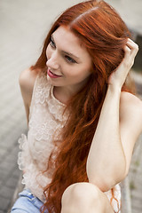 Image showing Pretty Blond Woman Sitting on Red Chair