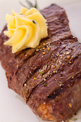 Image showing Grilled beef steak topped with butter and rosemary