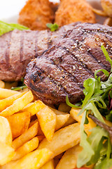 Image showing Platter of mixed meats, salad and French fries