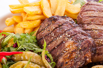 Image showing Platter of mixed meats, salad and French fries