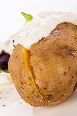 Image showing Baked jacket potato with sour cream sauce