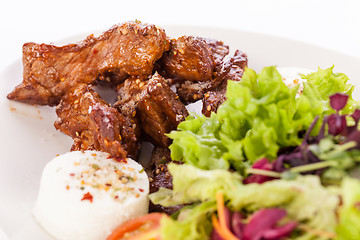 Image showing grilled beef stripes fresh salad and goat cheese