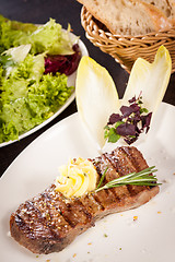 Image showing Grilled beef steak topped with butter and rosemary