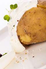 Image showing Baked jacket potato with sour cream sauce