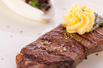 Image showing Grilled beef steak topped with butter and rosemary