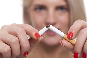 Image showing Close up Young Woman Breaking a Cigarette Stick