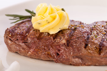 Image showing Grilled beef steak topped with butter and rosemary