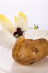 Image showing Baked jacket potato with sour cream sauce