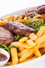 Image showing Platter of mixed meats, salad and French fries