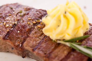 Image showing Grilled beef steak topped with butter and rosemary