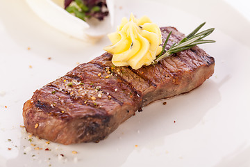 Image showing Grilled beef steak topped with butter and rosemary