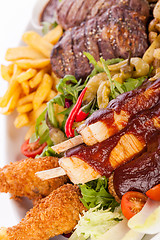 Image showing Platter of mixed meats, salad and French fries