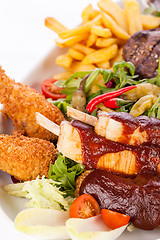 Image showing Platter of mixed meats, salad and French fries