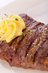 Image showing Grilled beef steak topped with butter and rosemary