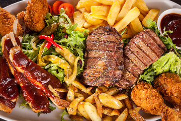 Image showing Platter of mixed meats, salad and French fries