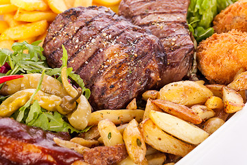 Image showing Platter of mixed meats, salad and French fries