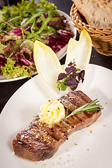 Image showing Grilled beef steak topped with butter and rosemary