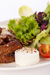 Image showing grilled beef stripes fresh salad and goat cheese