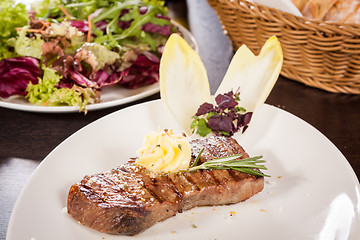 Image showing Grilled beef steak topped with butter and rosemary