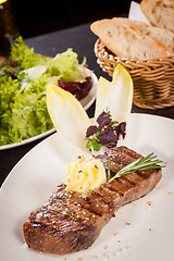 Image showing Grilled beef steak topped with butter and rosemary