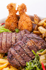 Image showing Platter of mixed meats, salad and French fries