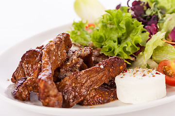 Image showing grilled beef stripes fresh salad and goat cheese