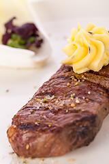 Image showing Grilled beef steak topped with butter and rosemary