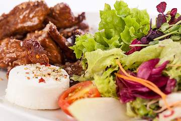 Image showing grilled beef stripes fresh salad and goat cheese