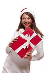 Image showing Pretty woman in a Santa hat with a large gift