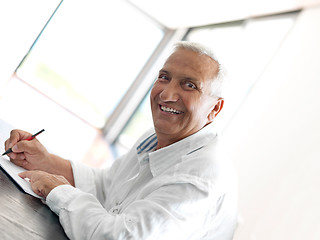 Image showing Portrait of senior man relaxing in sofa