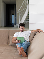 Image showing man using tablet computer from home