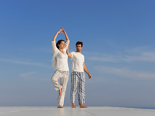 Image showing young couple practicing yoga